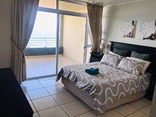 Beach front unit on 3rd floor offers 3 bedrooms, 2 bathrooms (shower & tub) of which one is an en-suite. Open plan kitchen, washing machine, dishwasher, dryer, large living room which leads out to the balcony that offers an amazing view and gas braai.Lounge equipped with an aircon and bedrooms equipped with ceiling fans. Approximate distance to beach 80 mtrs. DSTV connections (bring own decoder / card / cables), PVR's not compatible. Communal swimming pool, undercover secure parking. (2 double beds + 2 single beds) (Sleeps 6). Please note ALL our accommodation is SELF CATERING please bring your own bath / beach towels / dish cloths / toiletries / bin bags etc.