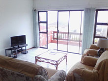 Modern spacious 2 bedroom, 2 bathroom unit in secure complex. Open plan lounge kitchen with balcony offering a distant sea view. Equipped with washing machine, DSTV connections (bring own decoder / card / cables) (Sleeps 4)