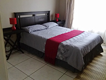 Located in the popular holiday destination of Uvongo, 1st floor unit consisting of 2 bedrooms, 1 bathroom (shower & tub). There is an open plan kitchen and living area, which leads out onto a balcony with braai. DSTV connections (bring own decoder / card / cables), PVR's not compatible. Undercover parking, communal swimming pool, approximately 400 mtrs to Uvongo main swimming beach. (1 double bed, 2¾ beds, 1 double sleeper couch - suitable for smaller children) (Sleeps 5).